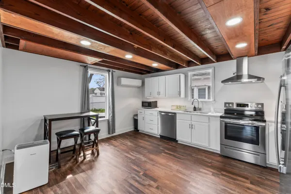 a kitchen with sink cabinets and wooden floor
