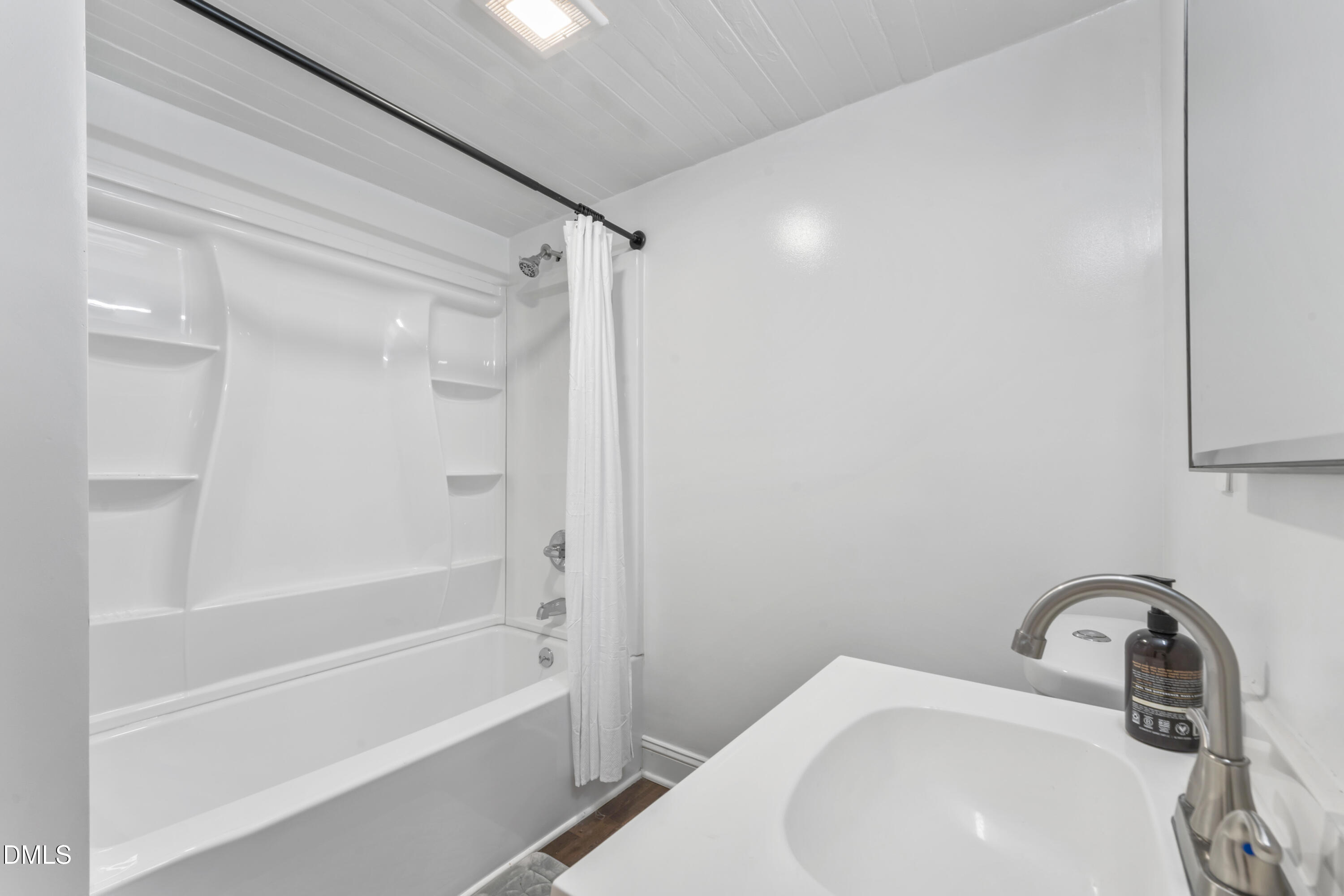 141 South Broad Street East Angier, NC 27501 - Photo 19 of 43 a bathroom with a sink a toilet and a bathtub