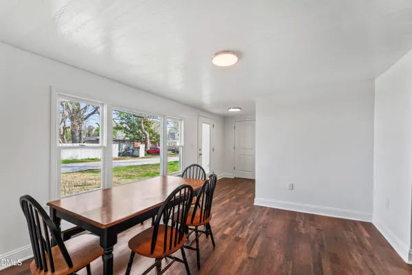 a view of a dining room with furniture and window
