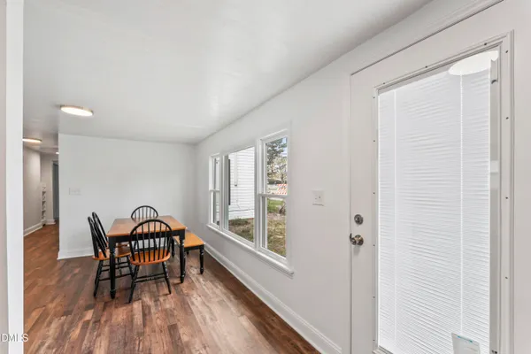 a view of a room with furniture and wooden floor