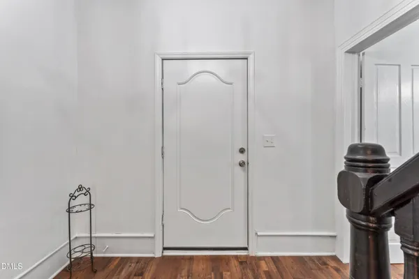 a picture of a room with wooden floor and cabinet