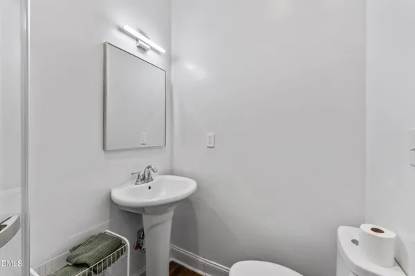 a bathroom with a sink a toilet and mirror