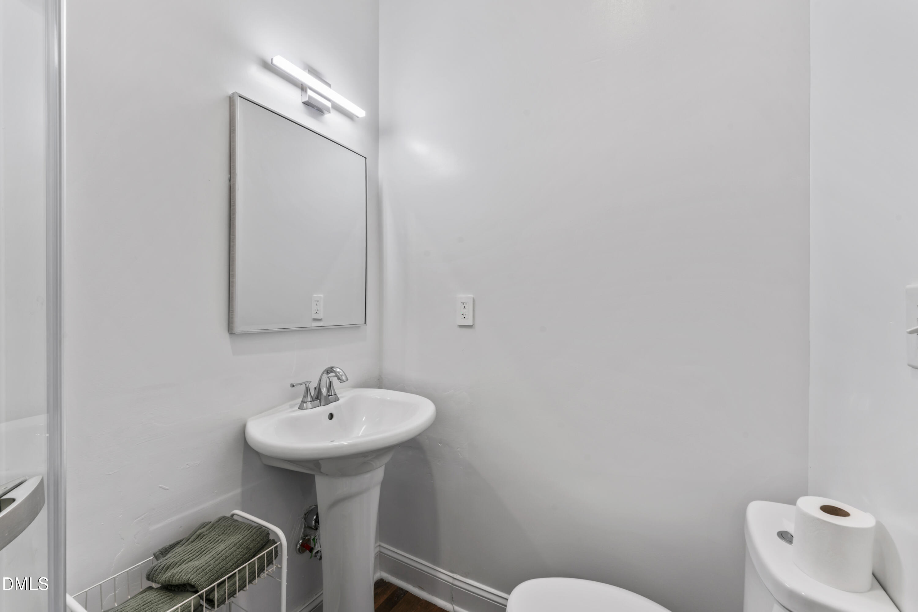 141 South Broad Street East Angier, NC 27501 - Photo 30 of 43 a bathroom with a sink a toilet and mirror