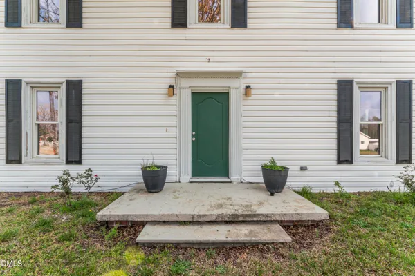 a view of a house with two chairs