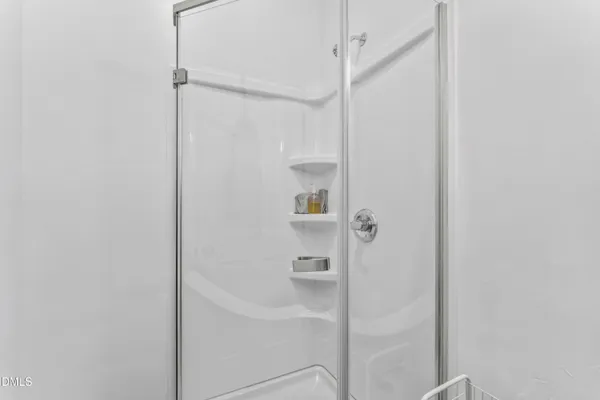 a bathroom with a glass shower door