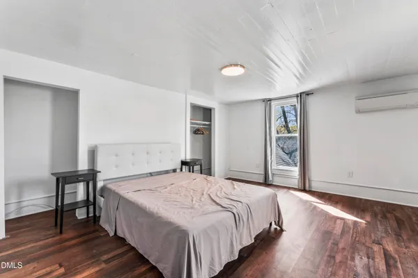 a bedroom with a bed and a table in it