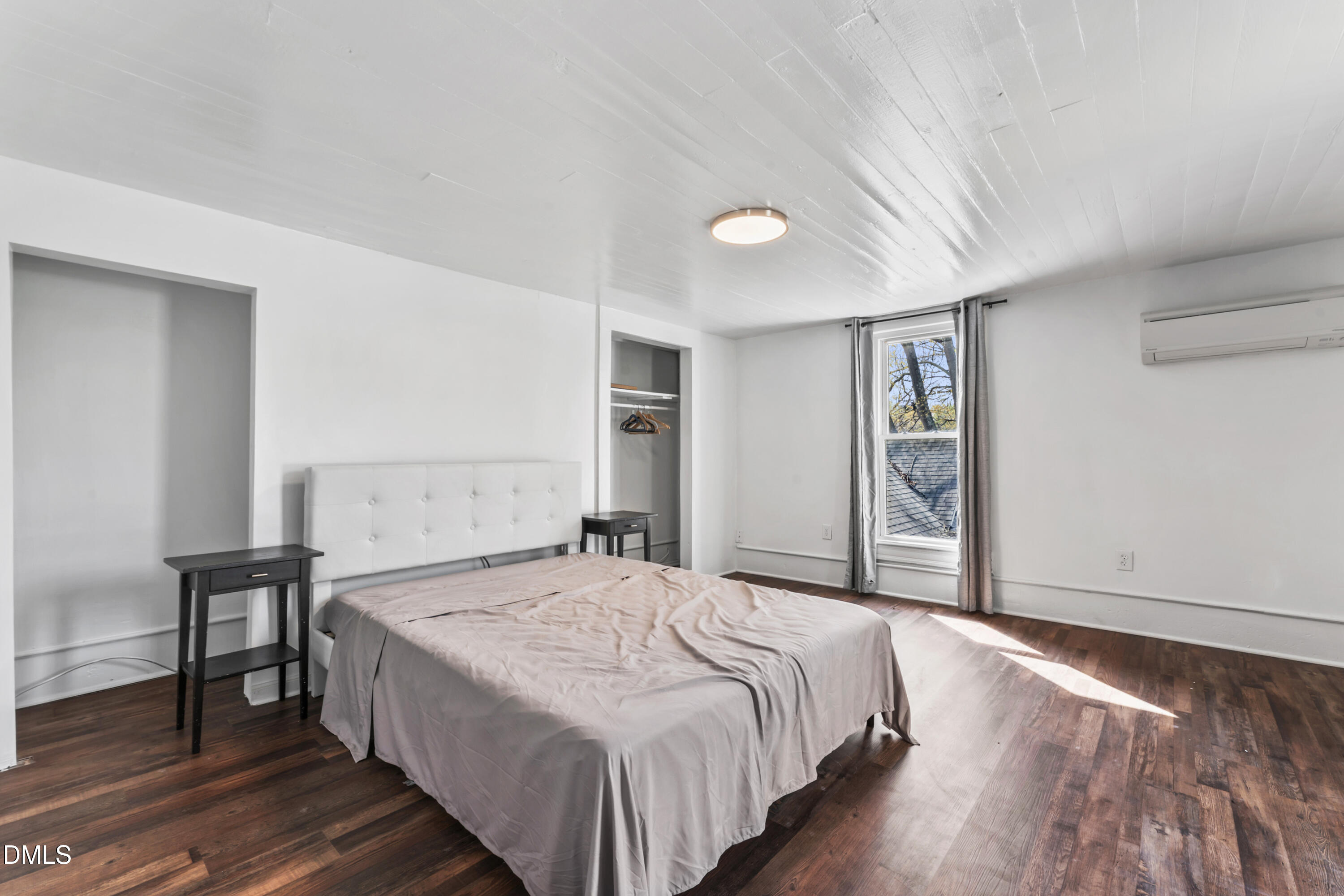 141 South Broad Street East Angier, NC 27501 - Photo 35 of 43 a bedroom with a bed and a table in it