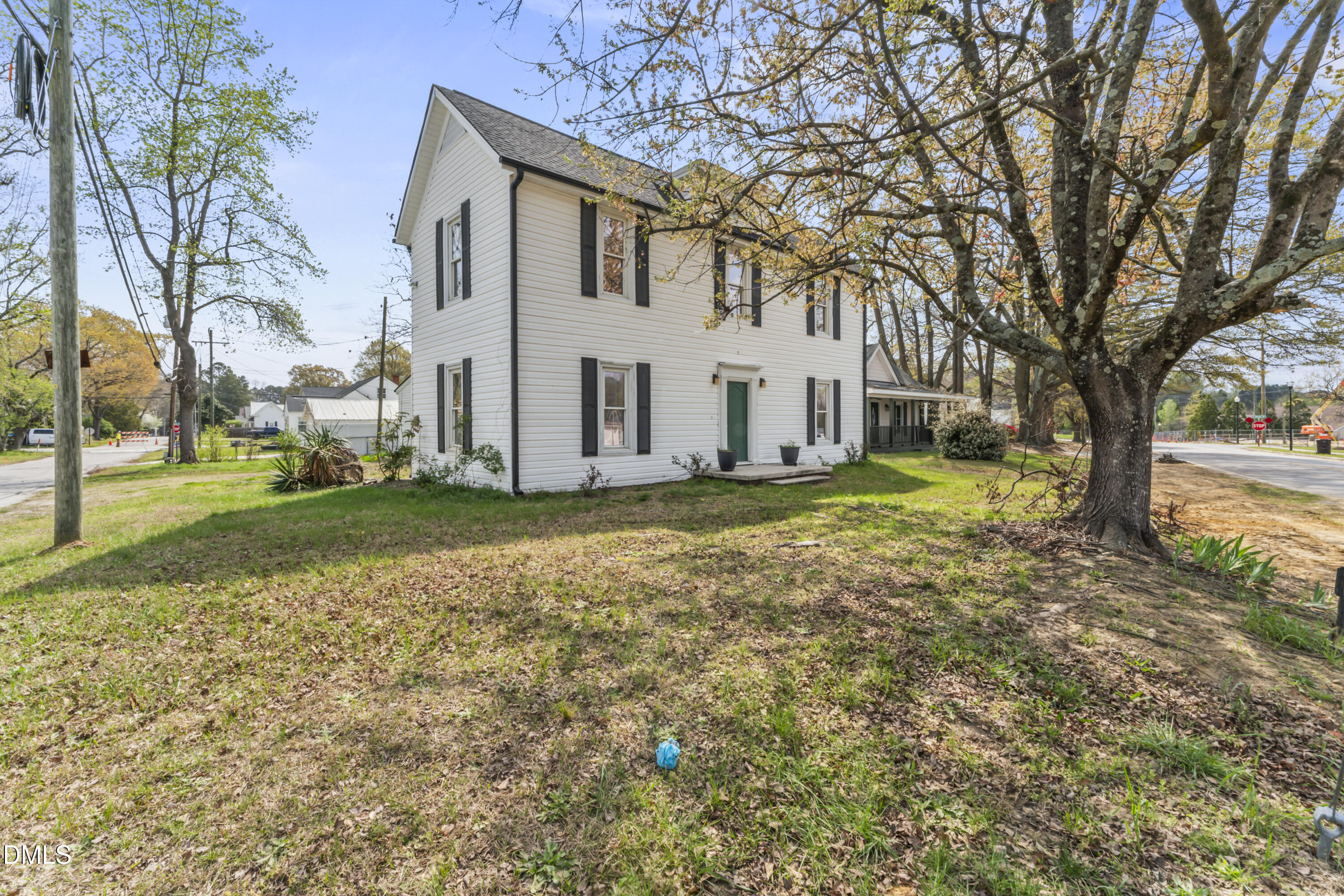 141 South Broad Street East Angier, NC 27501 - Photo 4 of 43 a view of a white house with a large tree in front of it