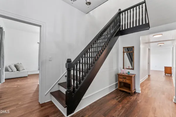a view of entryway and hall with wooden floor