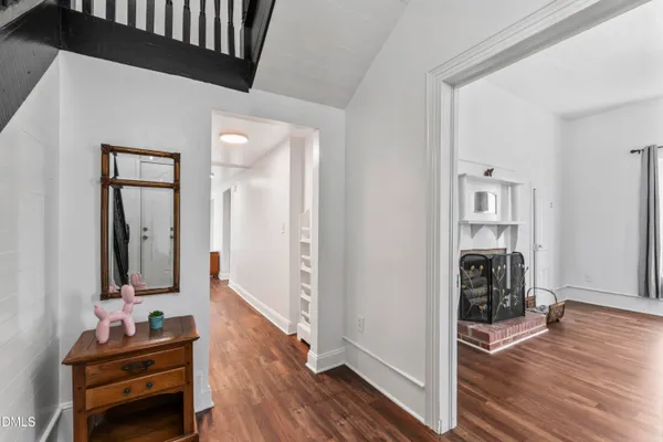 a hallway with wooden floor and furniture