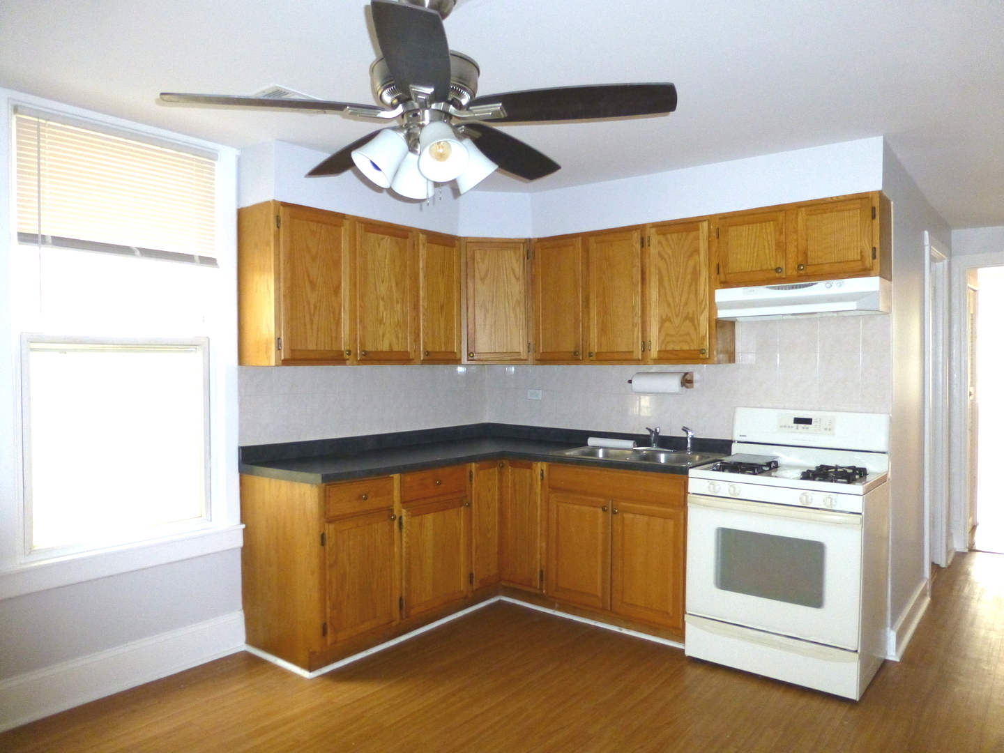 Undisclosed Address Chicago, IL 60647 - Photo 11 of 14 a kitchen with stainless steel appliances a stove a sink and a microwave