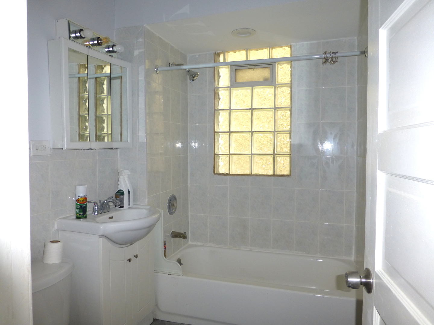 Undisclosed Address Chicago, IL 60647 - Photo 9 of 14 a white bath tub sitting next to a white sink and vanity