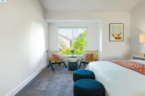 a bed room with two beds and a chair