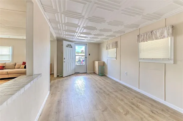 a view of a livingroom with wooden floor and furniture
