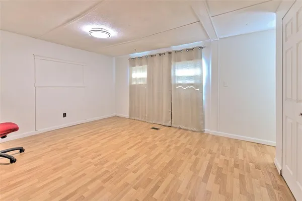 a view of an empty room and wooden floor