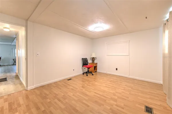 a view of a room with gym equipment and a window