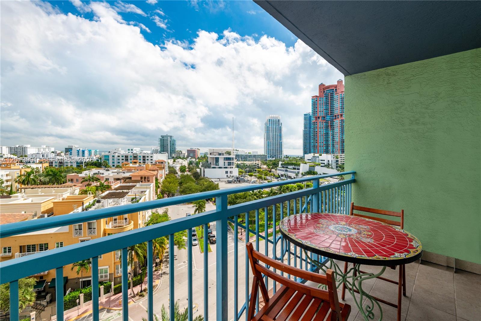 90 Alton Road, Unit 1007 Miami Beach, FL 33139 - Photo 1 of 25 a view of a balcony with a table and chairs