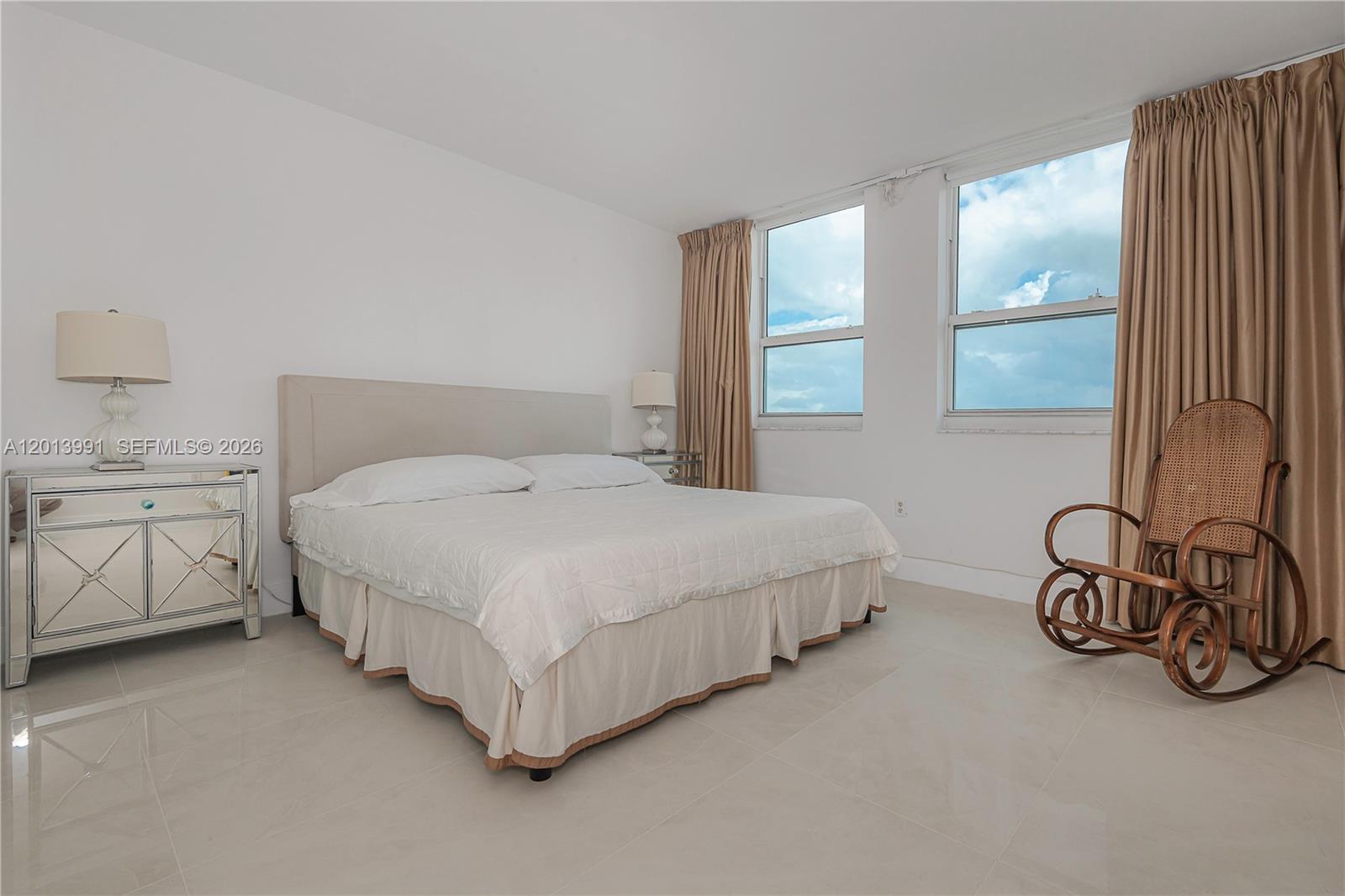 90 Alton Road, Unit 1007 Miami Beach, FL 33139 - Photo 18 of 25 a bed room with a bed and a window