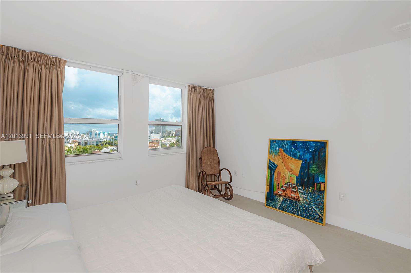 90 Alton Road, Unit 1007 Miami Beach, FL 33139 - Photo 19 of 25 a bedroom with a bed and a flat screen tv