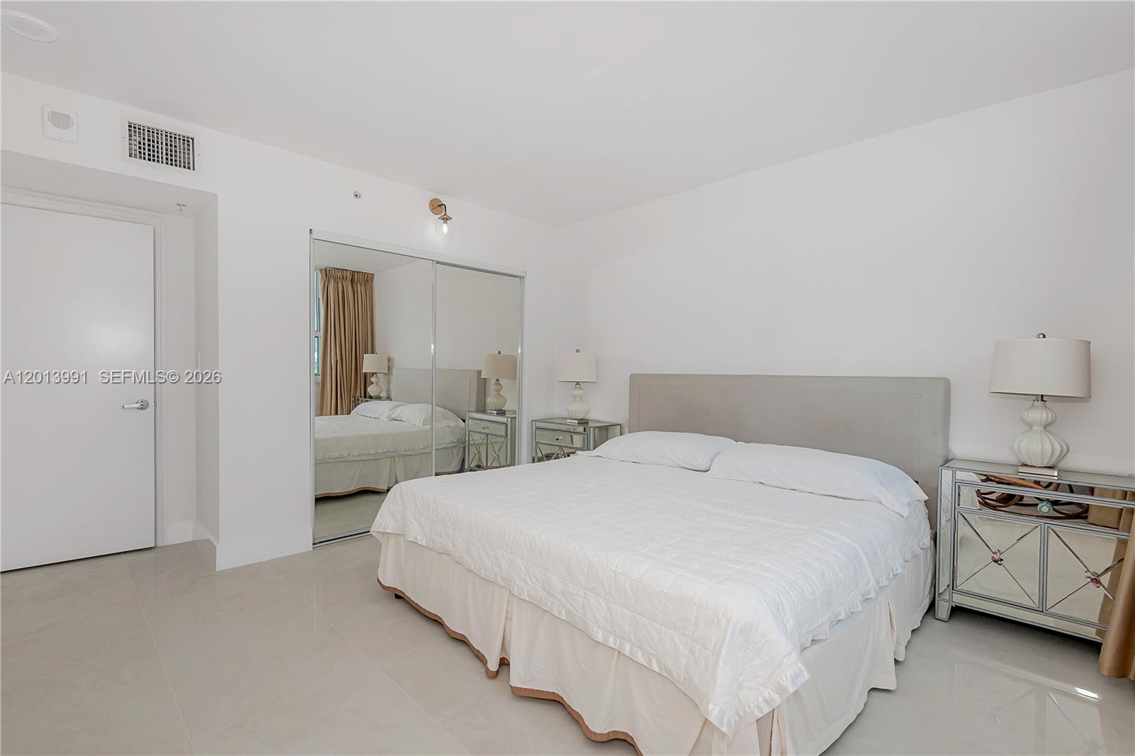90 Alton Road, Unit 1007 Miami Beach, FL 33139 - Photo 20 of 25 a large white bed in a white room