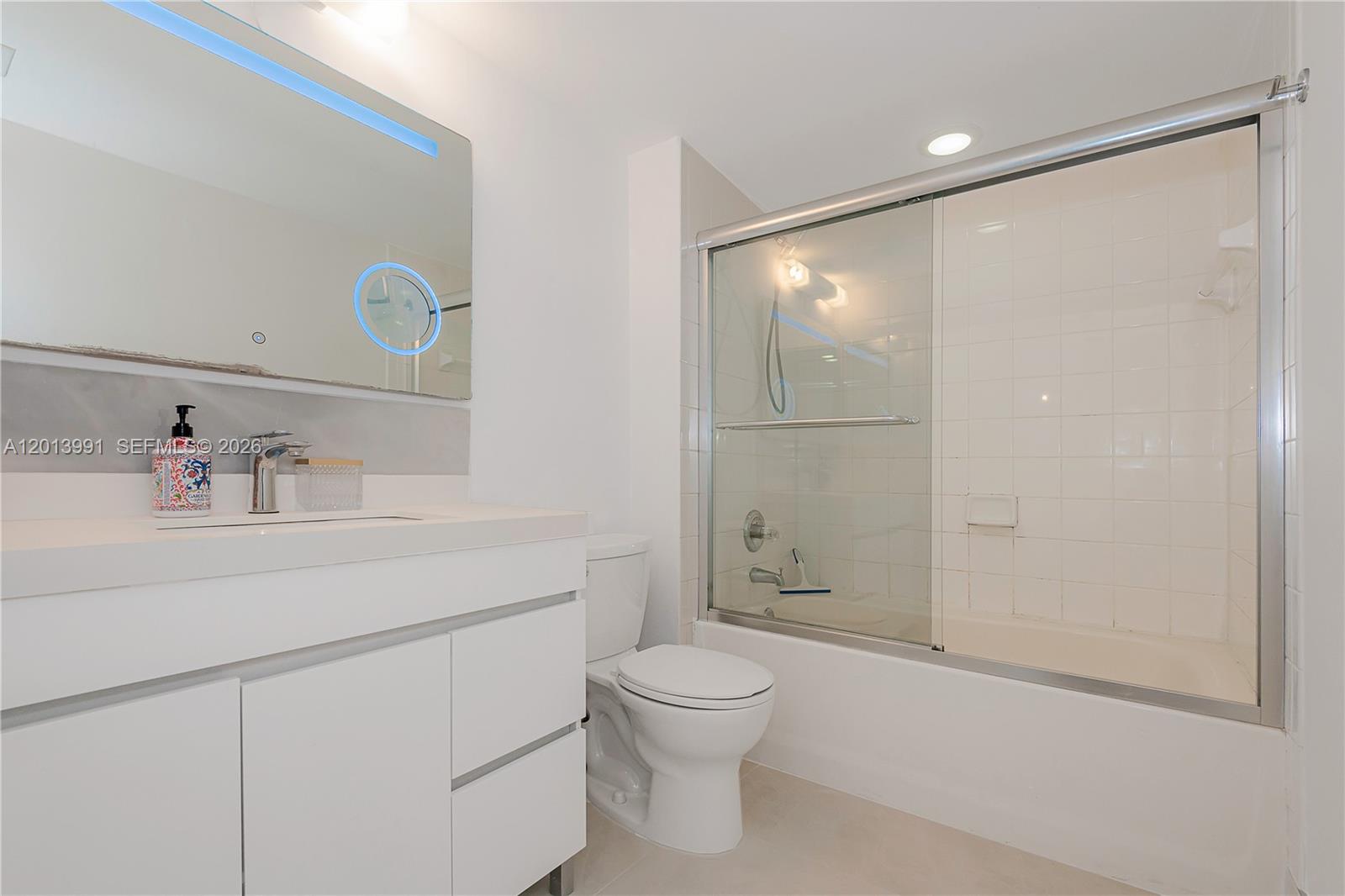 90 Alton Road, Unit 1007 Miami Beach, FL 33139 - Photo 21 of 25 a bathroom with a sink toilet and shower