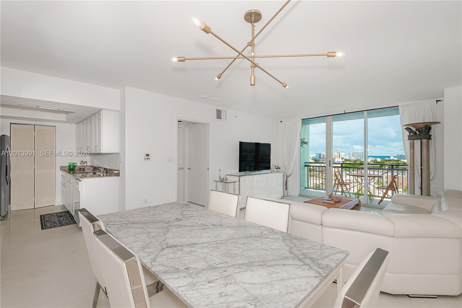 90 Alton Road, Unit 1007 Miami Beach, FL 33139 - Photo 6 of 25 a living room with furniture and a flat screen tv