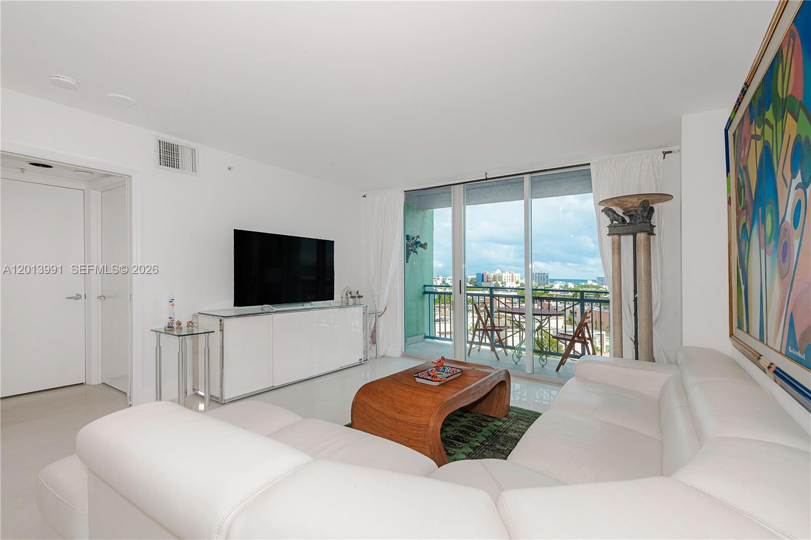 90 Alton Road, Unit 1007 Miami Beach, FL 33139 - Photo 7 of 25 a bedroom with a bed and a flat screen tv