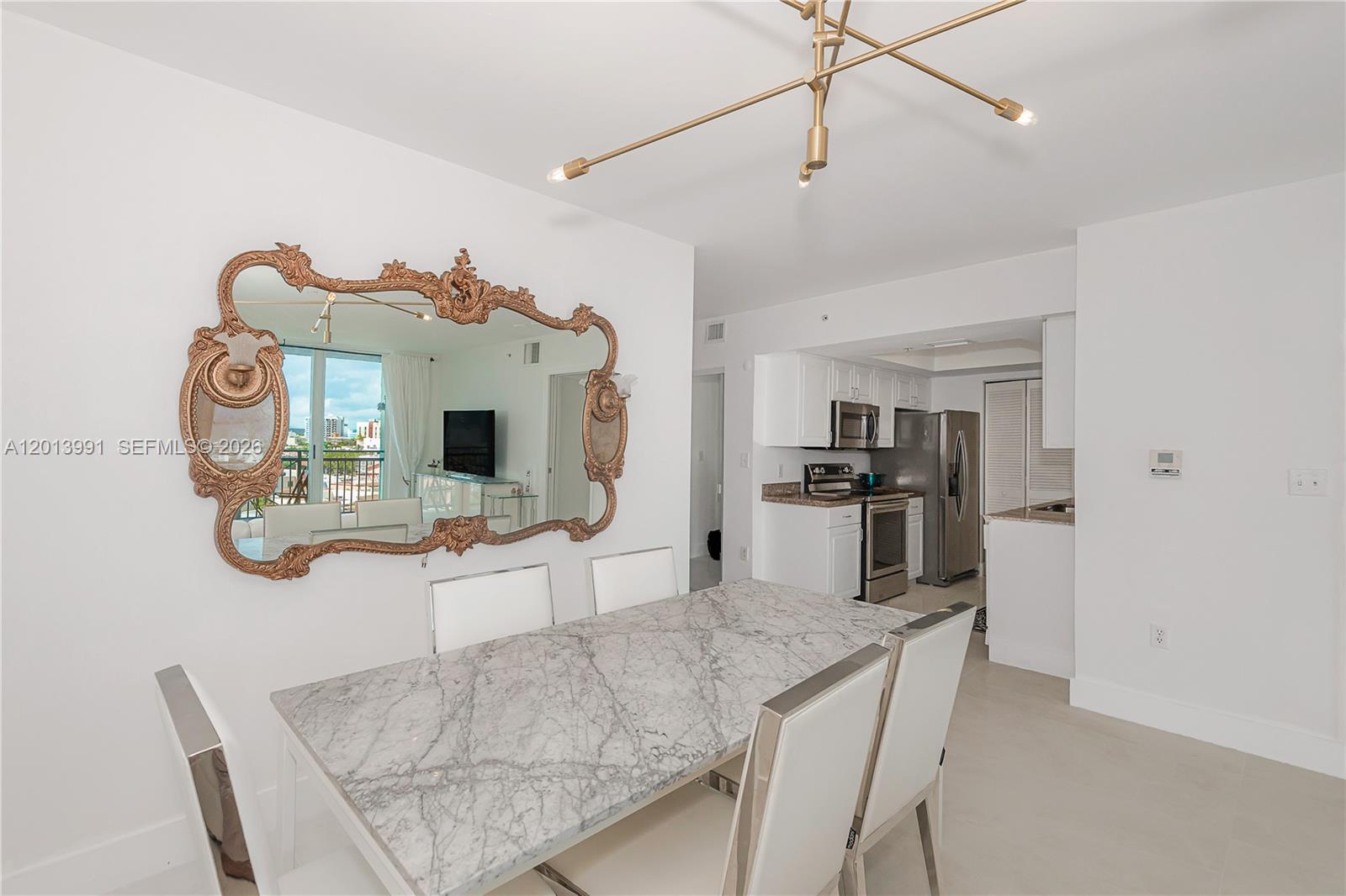 90 Alton Road, Unit 1007 Miami Beach, FL 33139 - Photo 9 of 25 a living room with furniture and flat screen tv