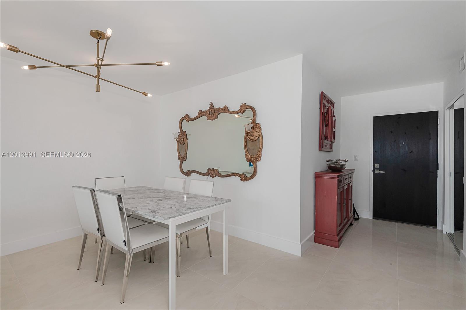 90 Alton Road, Unit 1007 Miami Beach, FL 33139 - Photo 10 of 25 a view of a dining room with furniture