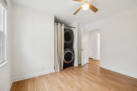 a view of a livingroom with wooden floor and white walls