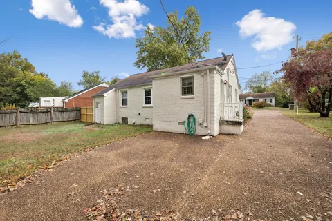 a view of a house with a yard and garage