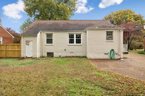 a backyard of a house with yard and trees
