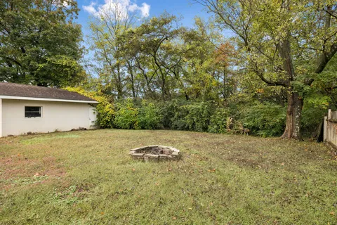 an aerial view of a houses with a yard and lake view