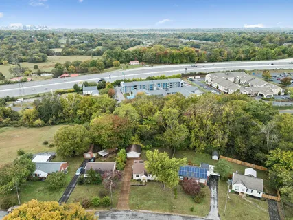 an aerial view of a houses with a yard