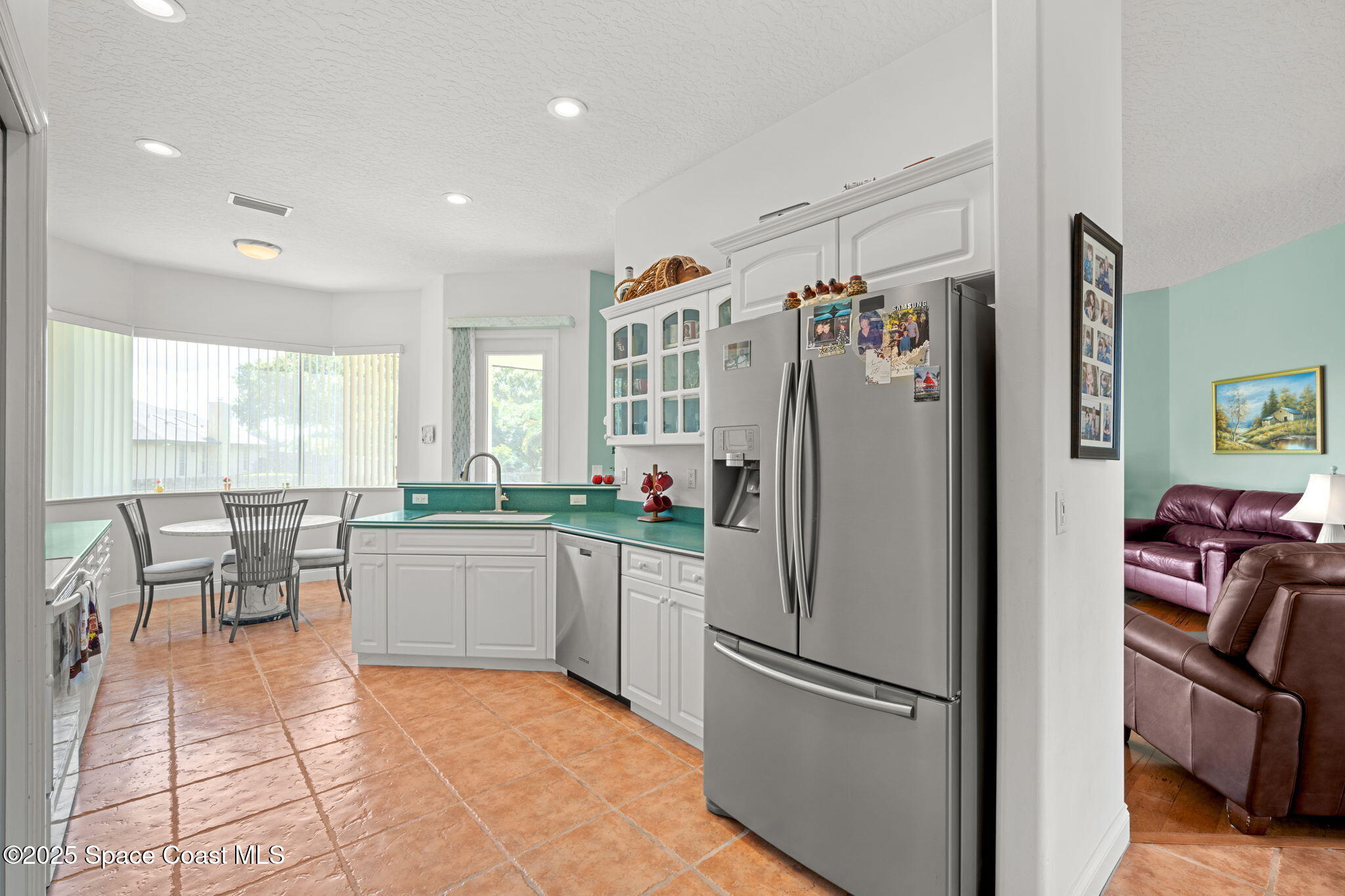 415 Indian Bay Boulevard Merritt Island, FL 32953 - Photo 11 of 37 a kitchen with a refrigerator and a sink