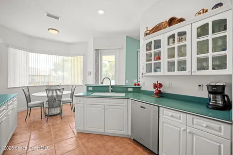 a kitchen with a refrigerator and a sink