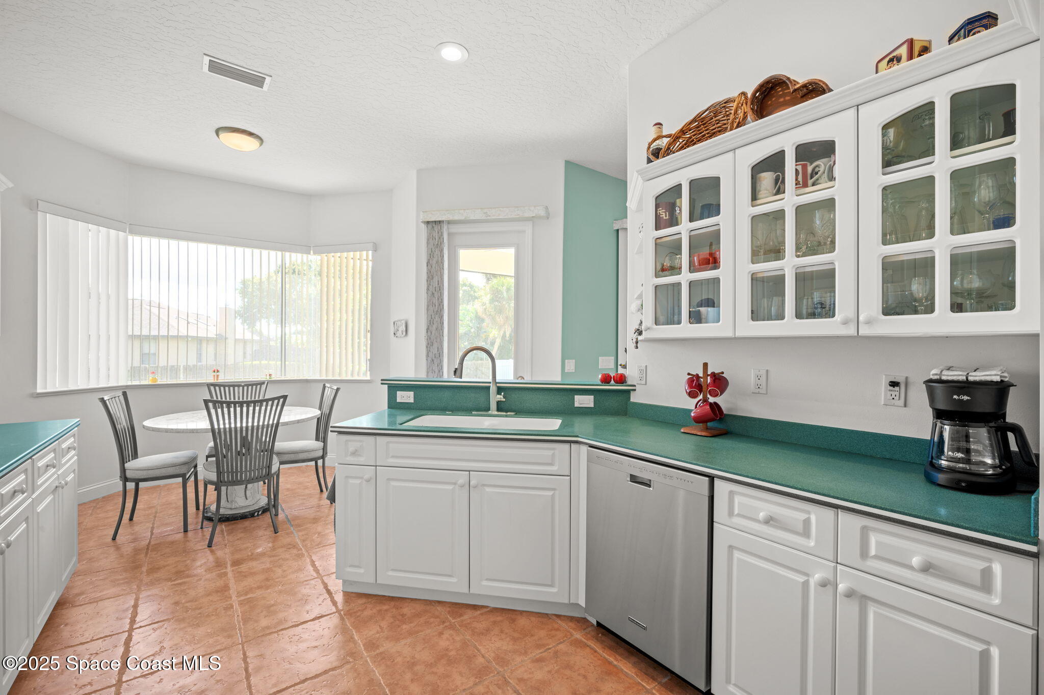 415 Indian Bay Boulevard Merritt Island, FL 32953 - Photo 12 of 37 a kitchen with a sink and cabinets