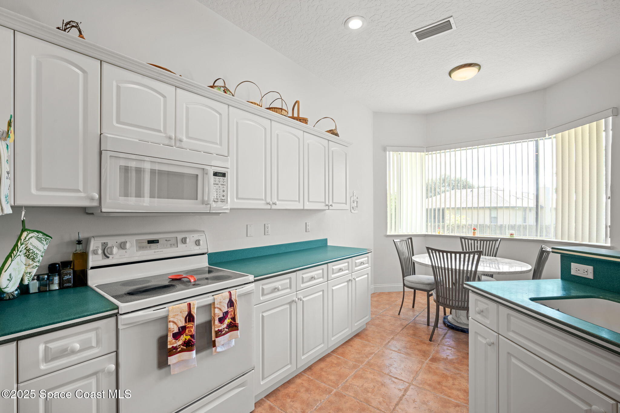 415 Indian Bay Boulevard Merritt Island, FL 32953 - Photo 13 of 37 a kitchen that has a lot of cabinets in it and appliances