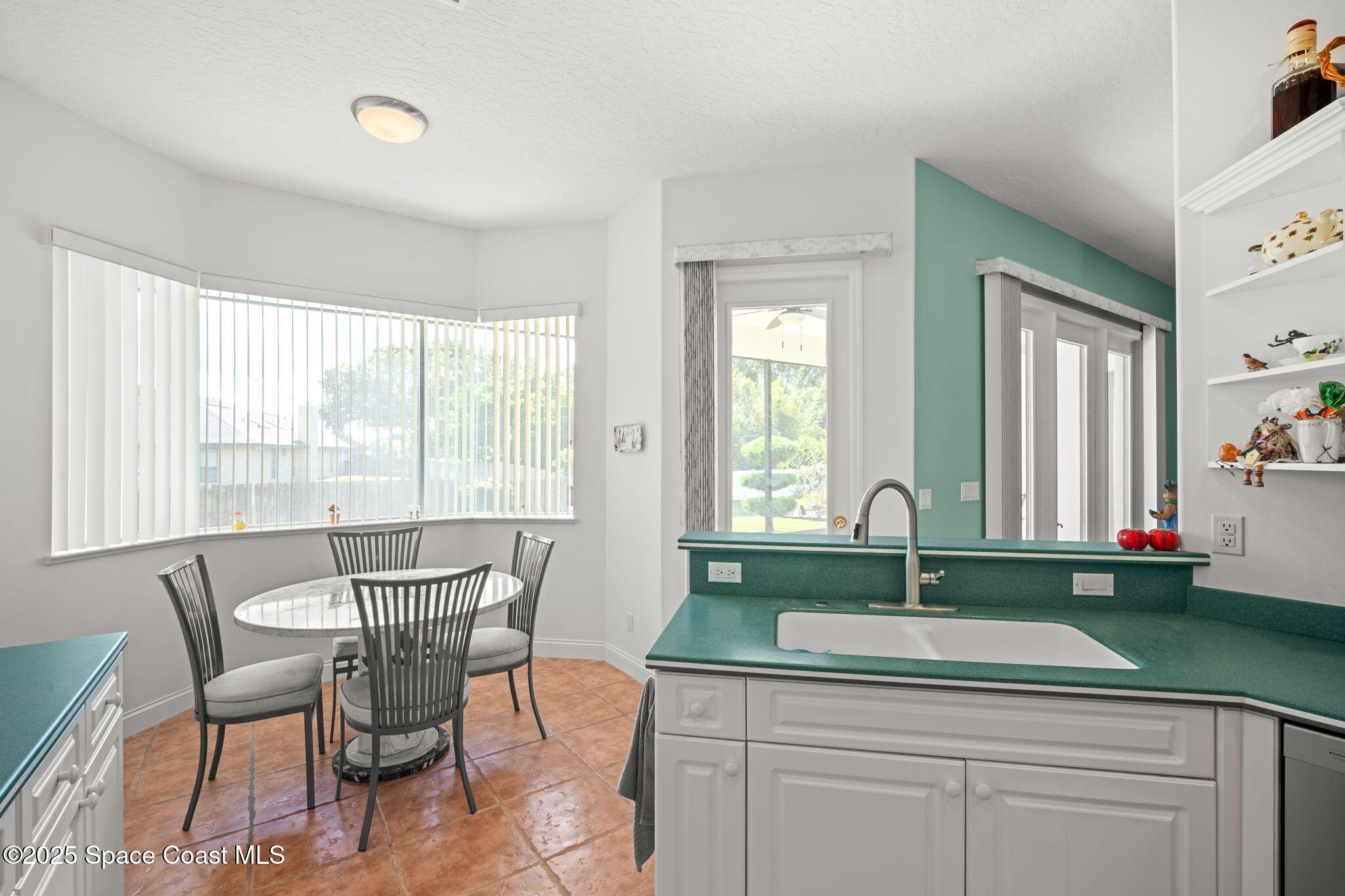 415 Indian Bay Boulevard Merritt Island, FL 32953 - Photo 14 of 37 a kitchen with a sink and cabinets