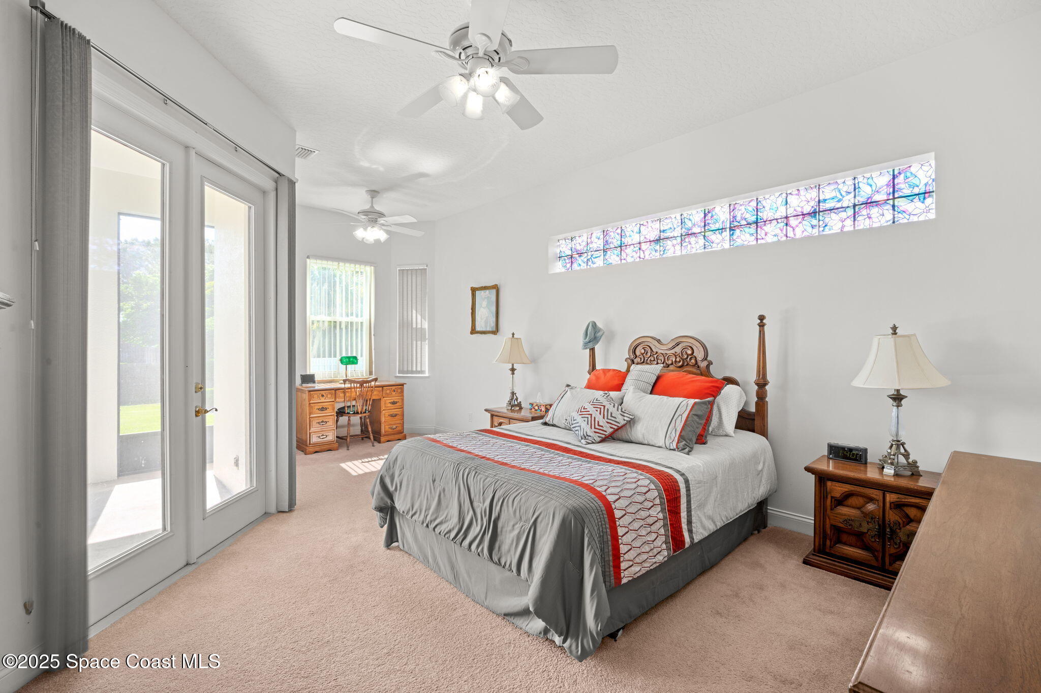 415 Indian Bay Boulevard Merritt Island, FL 32953 - Photo 16 of 37 a bedroom with a bed ceiling fan and a window