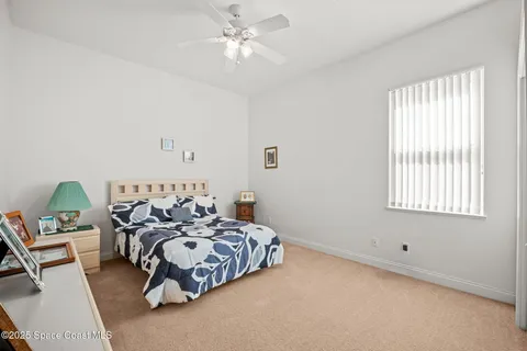 a bathroom with a granite countertop bathtub sink vanity and two mirror