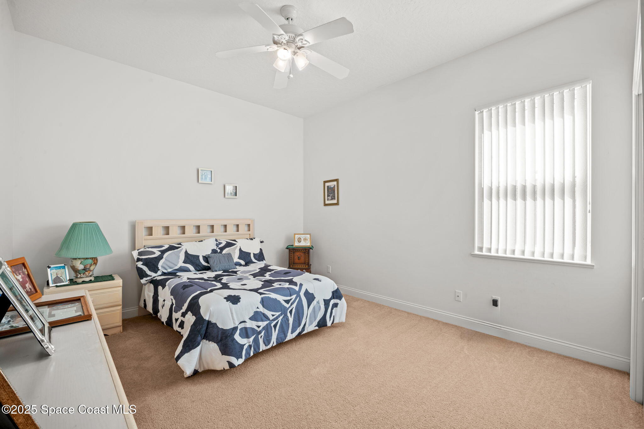 415 Indian Bay Boulevard Merritt Island, FL 32953 - Photo 20 of 37 a bedroom with a bed and a chandelier