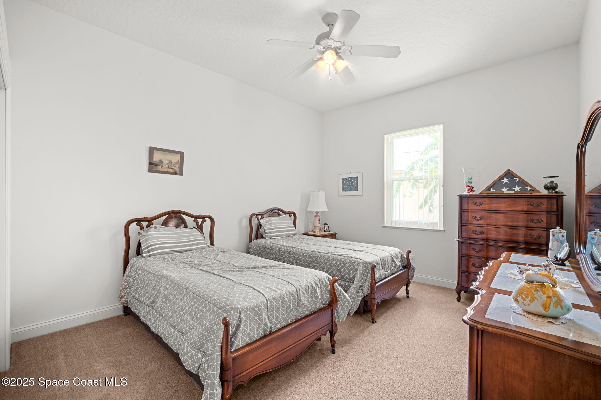 415 Indian Bay Boulevard Merritt Island, FL 32953 - Photo 22 of 37 a bedroom with two beds and a window