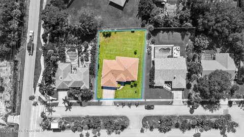 a view of a house with a yard and sitting area