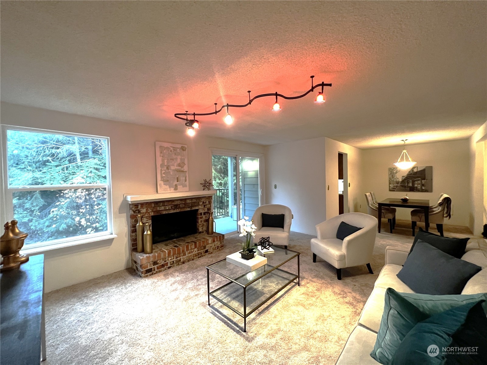 820 Cady Road, Unit C203 Everett, WA 98203 - Photo 13 of 19 a living room with furniture a fireplace and a floor to ceiling window