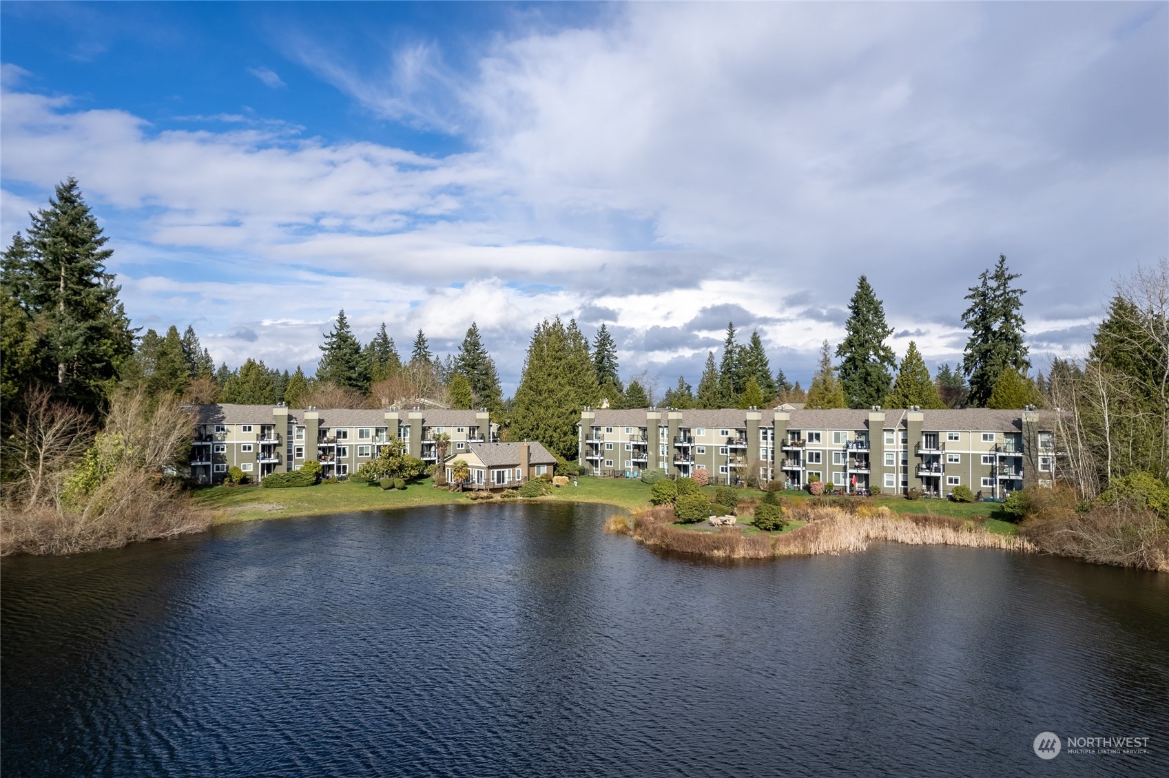 820 Cady Road, Unit C203 Everett, WA 98203 - Photo 7 of 19 a view of a lake with boats and trees in the background