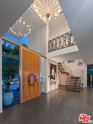 a living room with furniture and a book shelf