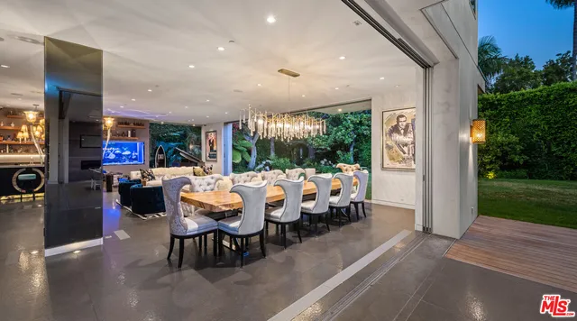a bathroom with a double vanity sink a large mirror and a bathtub