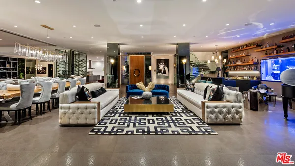 a living room with furniture and large windows