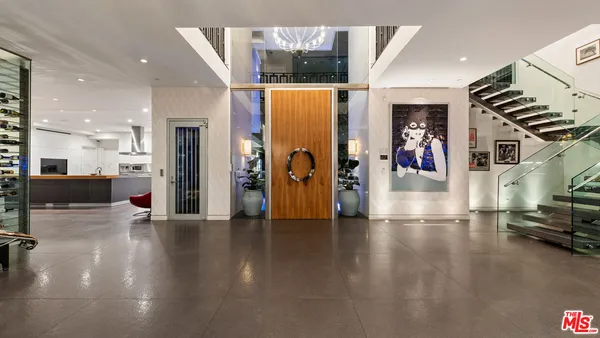 a spacious bedroom with a bed window and a flat screen tv